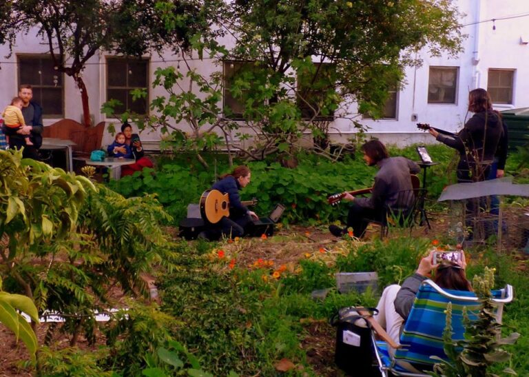 Jamming during Covid in LAEV courtyard. Photo: Eco-Villagers make socially distanced music in their courtyard during Covid-19
