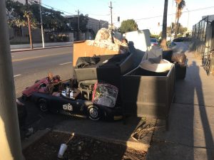 Homeless Henry builds a "home" in front of the Hub.