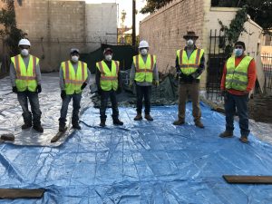 Marcos and crew on tarped toxic earth